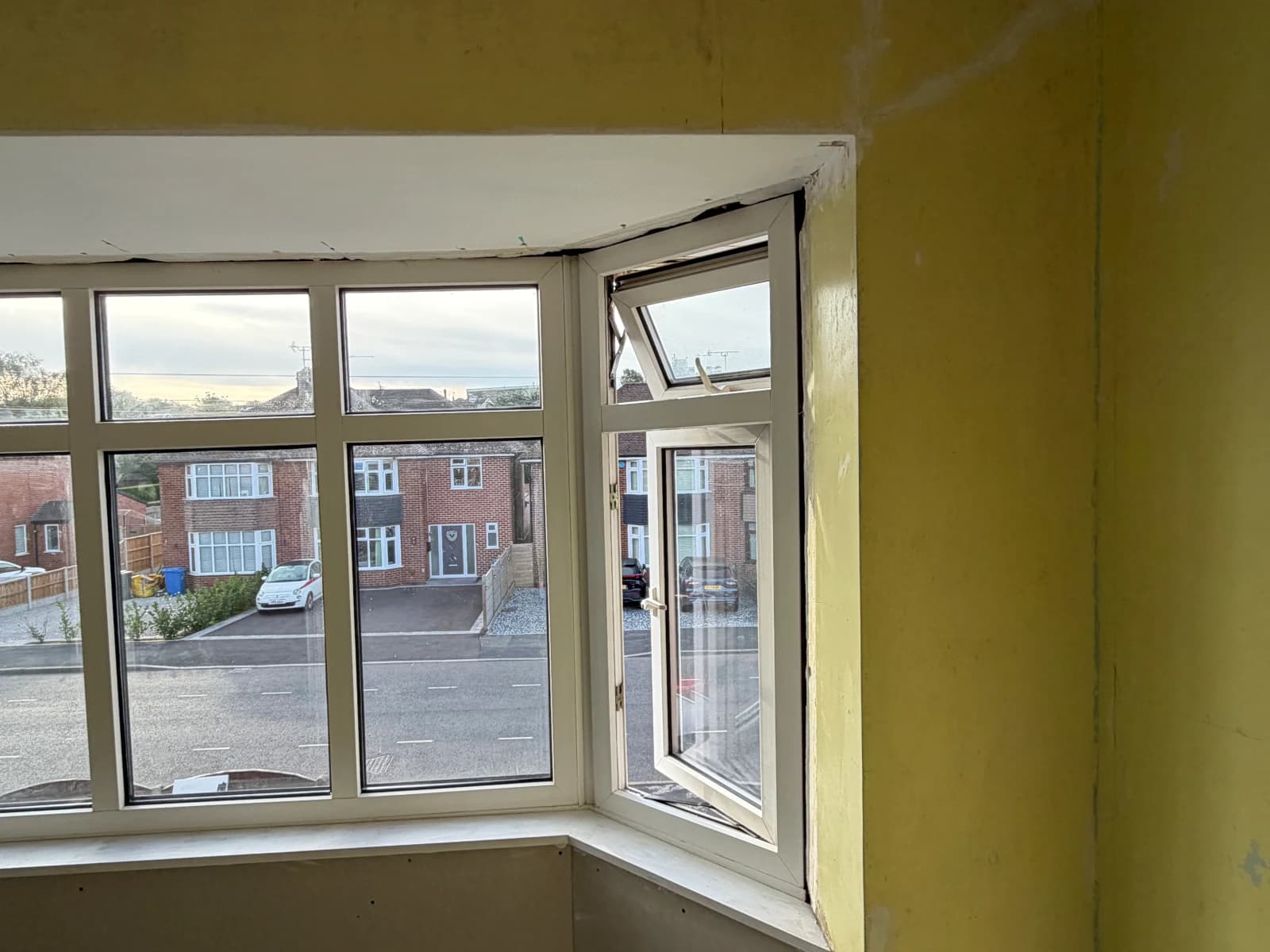 Gaps and damaged plaster around the bedroom bay window reveal before repairs