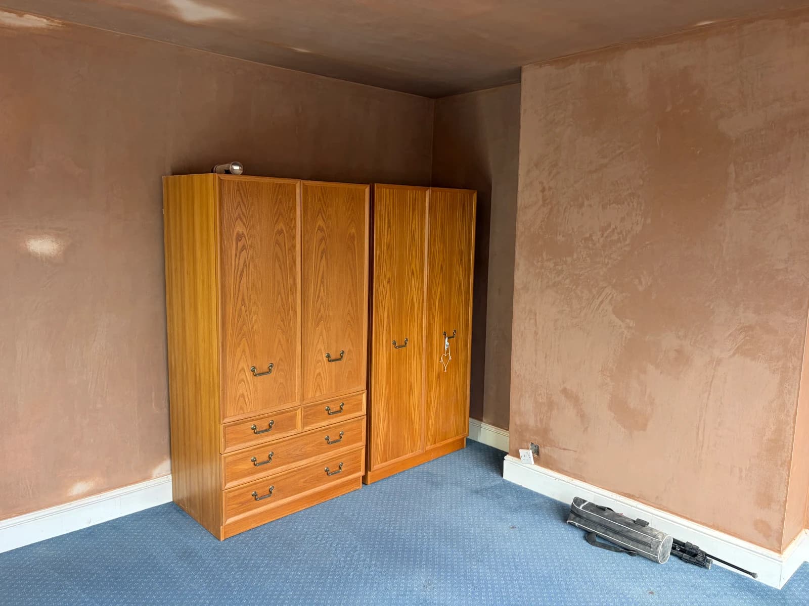 Freshly skimmed bedroom walls around the retained wardrobe in Allestree