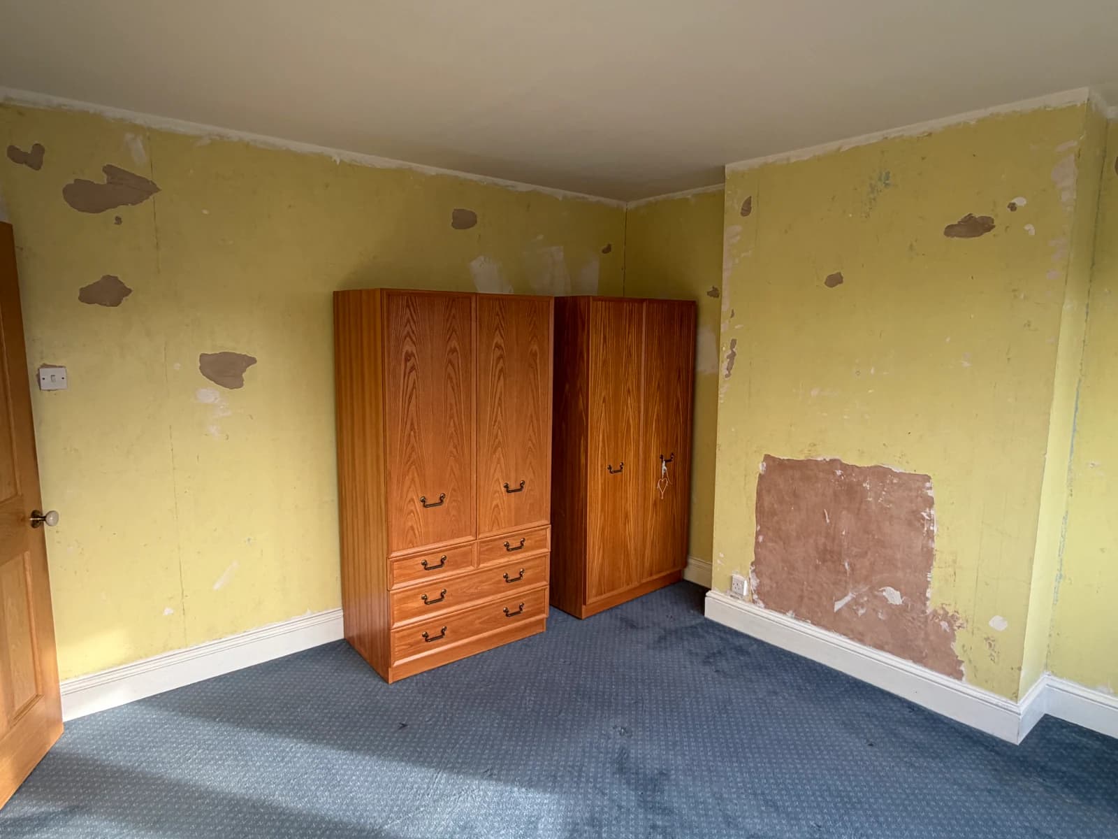 Bedroom walls in Allestree with stripped surfaces and damaged plaster before preparation