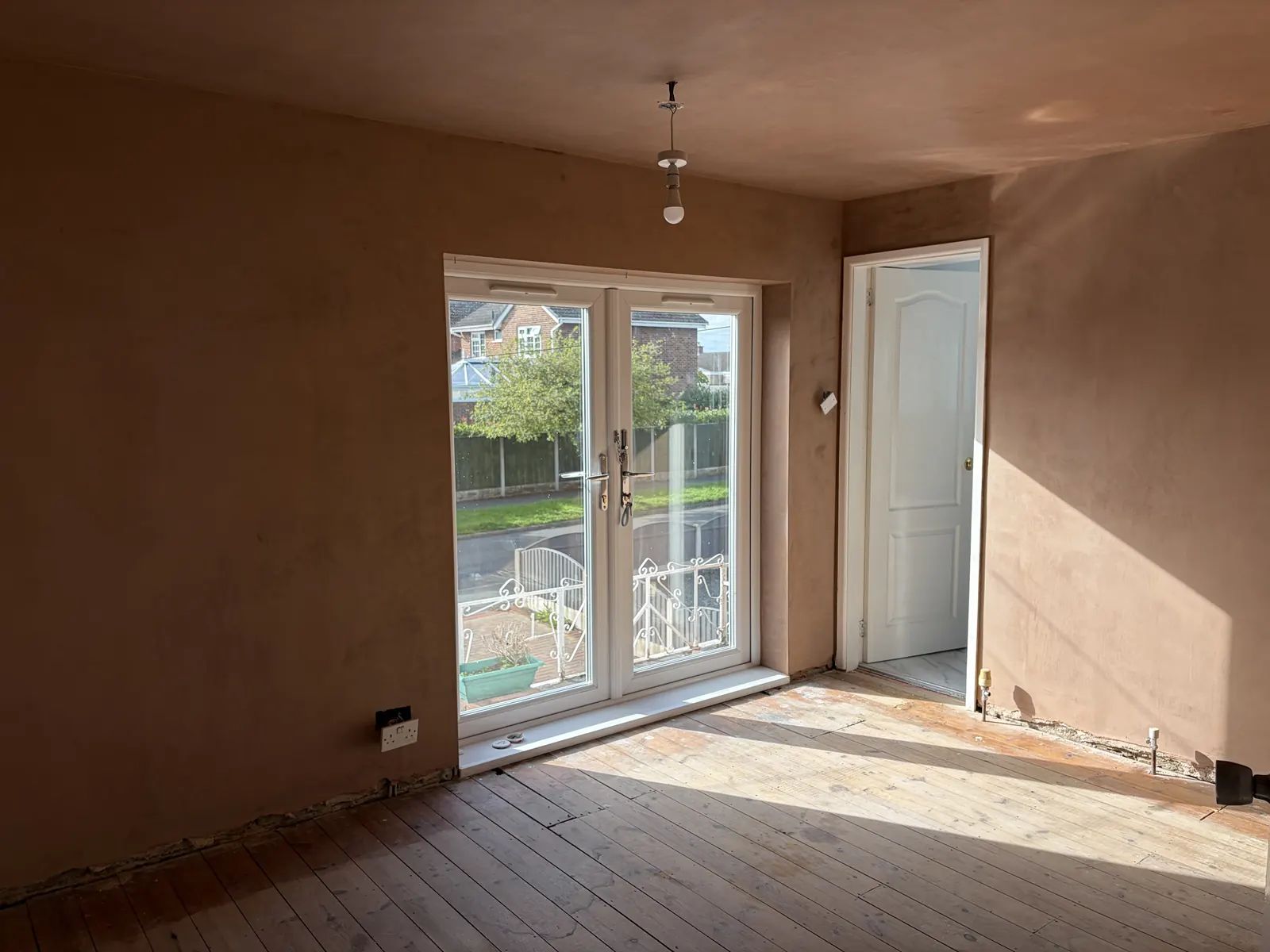 The same Allestree bedroom after a complete skim of the walls and ceiling, with fresh plaster drying