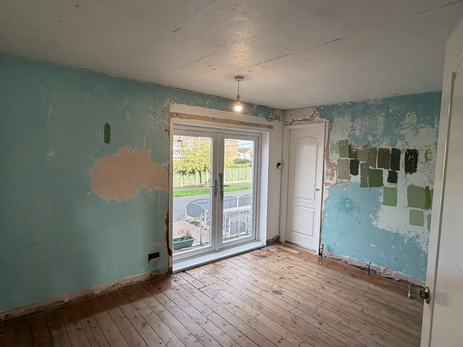 Allestree bedroom with stripped, patchy walls and an old ceiling finish before plastering