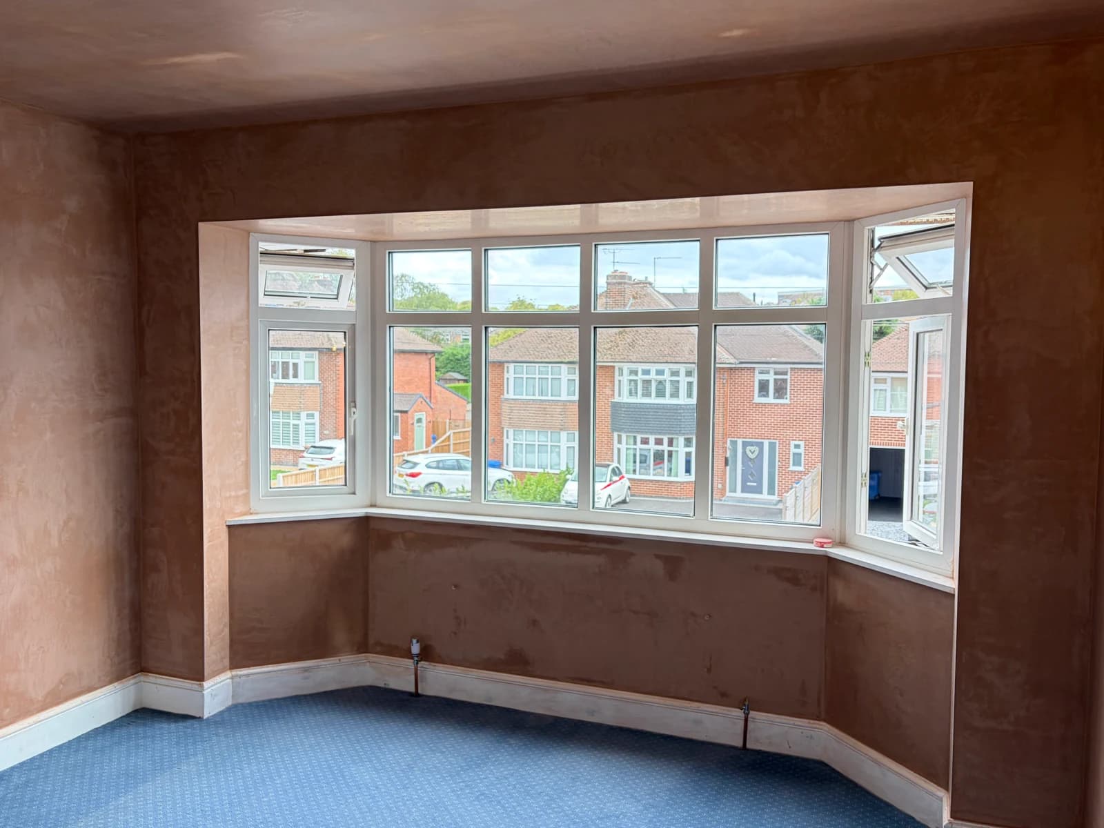 Completed bedroom plastering around a bay window in Allestree